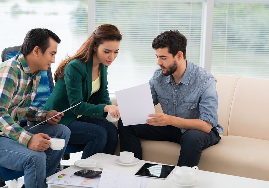 Group of business people discussing financial documents in the office